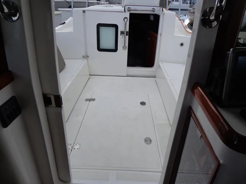 Slide: The Image of 2020 SeaPiper Pilothouse boat interior with open door and seating area. - 25