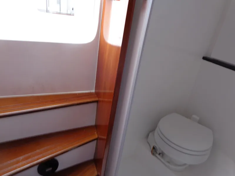 Slide: The Image of Interior of 2020 SeaPiper Pilothouse showing wooden stairs and compact marine toilet. - 27