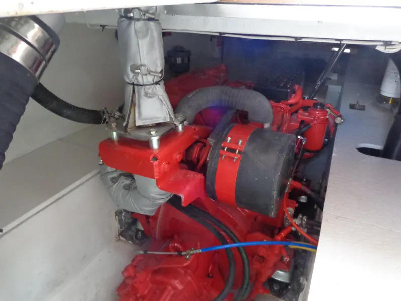 Slide: The Image of 2020 SeaPiper Pilothouse engine compartment with red machinery and hoses. - 36