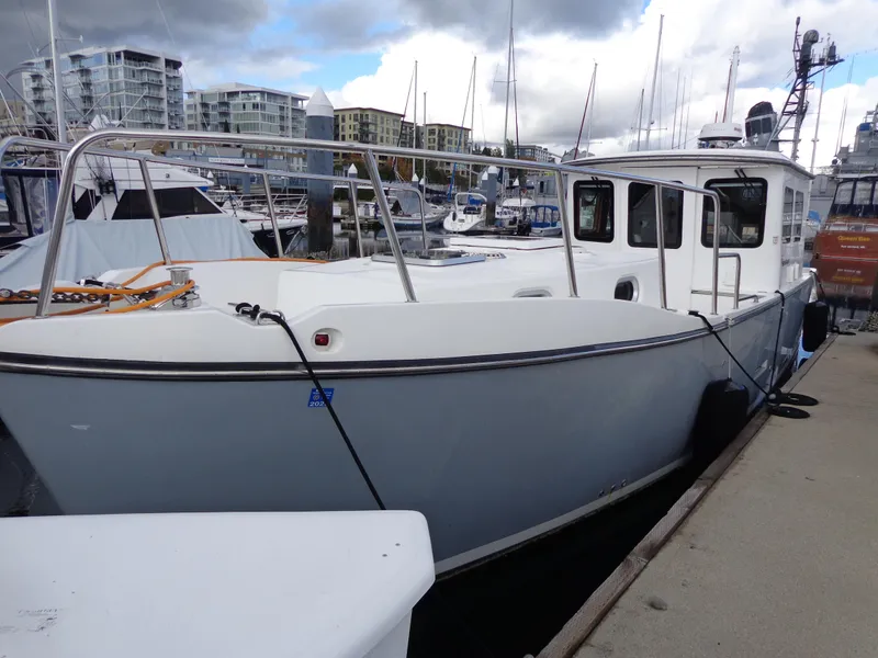 Slide: The Image of 2020 SeaPiper Pilothouse boat docked in a marina with cloudy skies. - 43