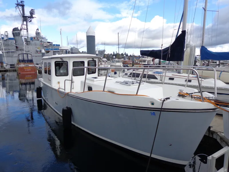 Slide: The Image of 2020 SeaPiper Pilothouse boat docked in a marina, surrounded by other vessels. - 48