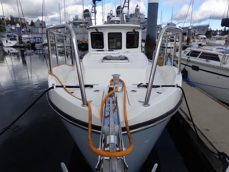 Slide: The Image of 2020 SeaPiper Pilothouse boat docked in marina, front view. - 9