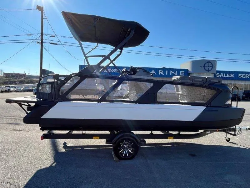 Slide: The Image of 2024 Sea-Doo Switch Cruise 21' 230HP pontoon boat in a dealership lot. - 11