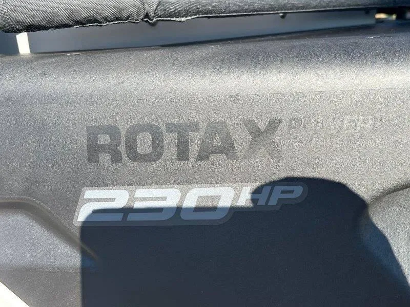 Slide: The Image of Close-up of 2024 Sea-Doo Switch Cruise 21' 230HP Rotax engine branding. - 13