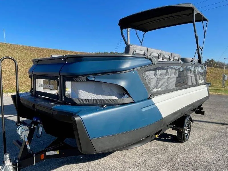 Slide: The Image of 2024 Sea-Doo Switch Cruise 21' 230HP boat on trailer, blue and white design. - 14