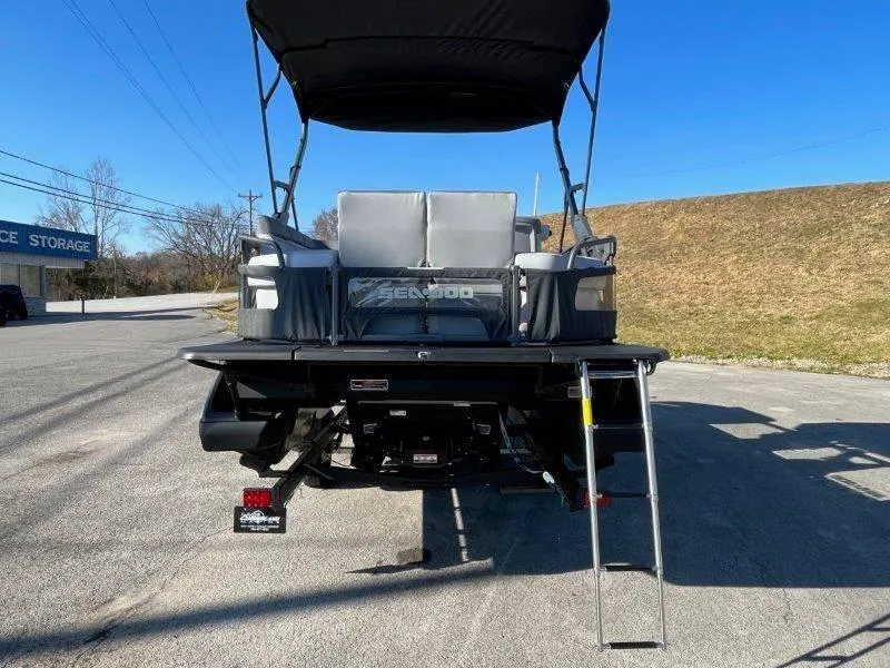 Slide: The Image of 2024 Sea-Doo Switch Cruise 21' 230HP pontoon boat rear view with ladder. - 15