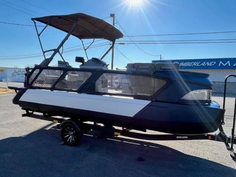 Slide: The Image of 2024 Sea-Doo Switch Cruise 21' 230HP pontoon boat on trailer, sunny day. - 16