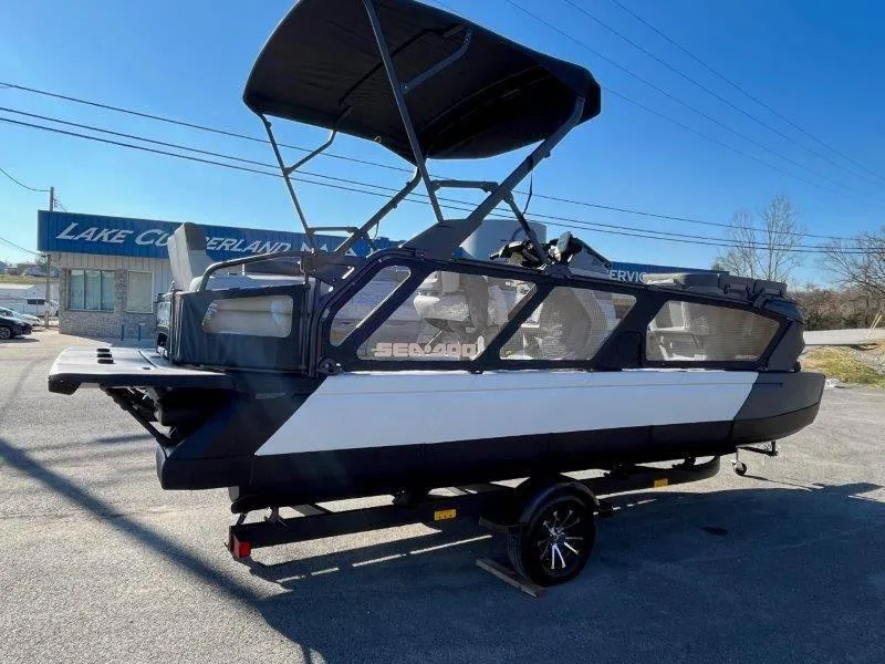 Slide: The Image of 2024 Sea-Doo Switch Cruise 21' 230HP pontoon boat on trailer, parked outdoors. - 18