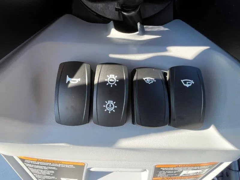 Slide: The Image of 2024 Sea-Doo Switch Cruise 21' control panel with four black switches. - 19