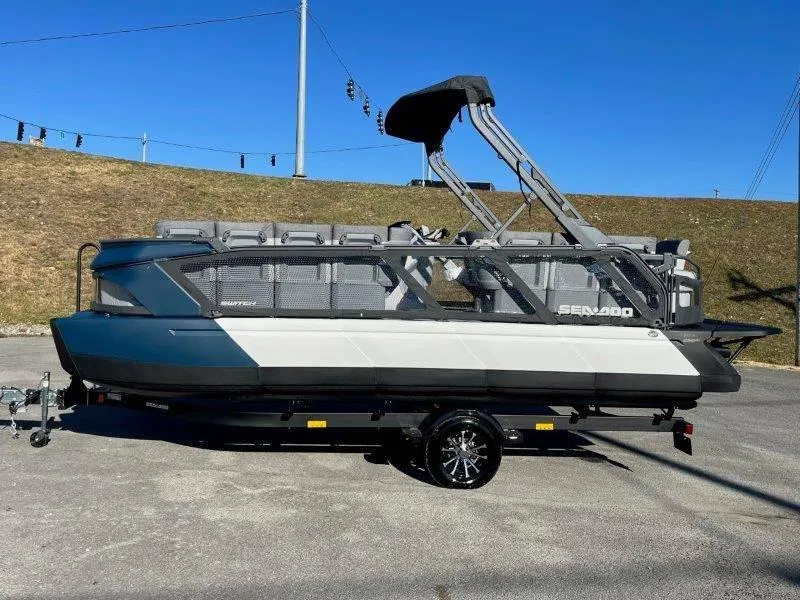 Slide: The Image of 2024 Sea-Doo Switch Cruise 21' 230HP pontoon boat on trailer, parked outdoors. - 38