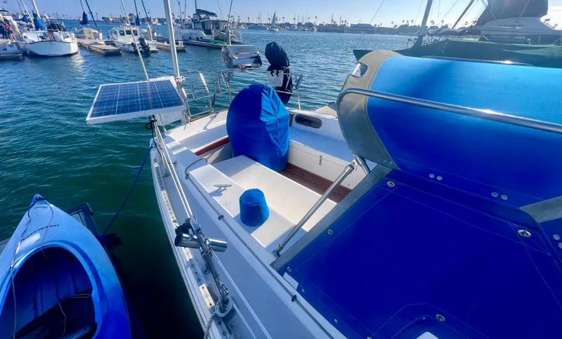 Slide: The Image of 1983 Catalina 36 sailboat docked with solar panel and blue kayak nearby. - 10