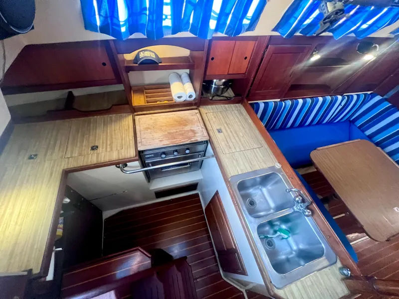 Slide: The Image of Interior of 1983 Catalina 36 sailboat with kitchen and dining area. - 23