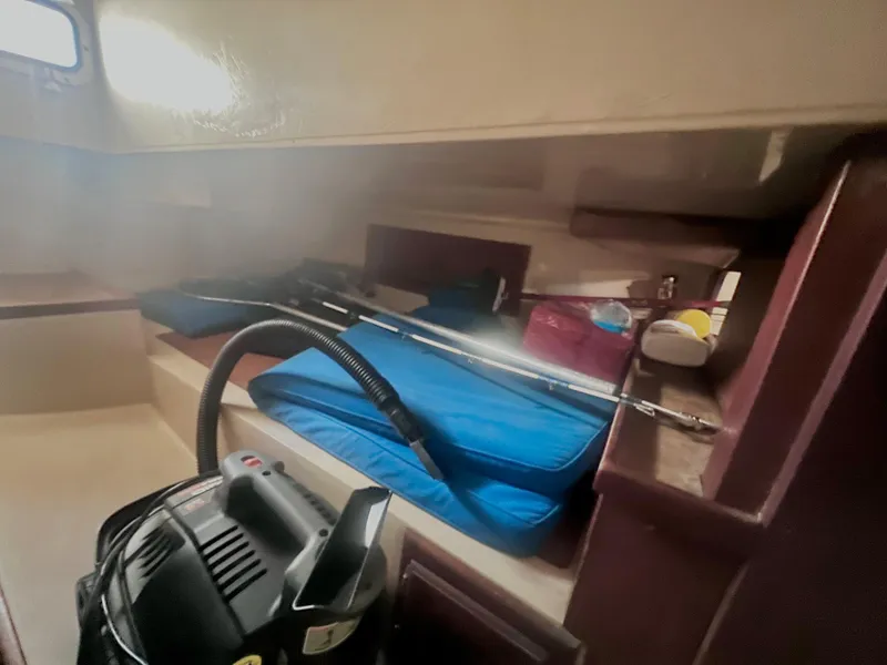 Slide: The Image of Interior of a 1983 Catalina 36 sailboat with cleaning equipment and storage items. - 37