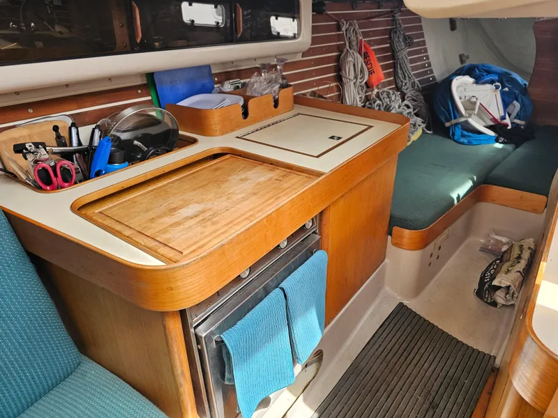 Slide: The Image of Interior of 1987 Express 37 sailboat with wooden cabinetry and seating area. - 12