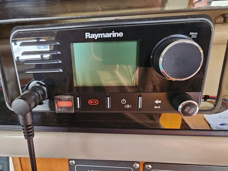 Slide: The Image of Raymarine marine radio system on Express 37, 1987 model, with control knobs and display. - 15