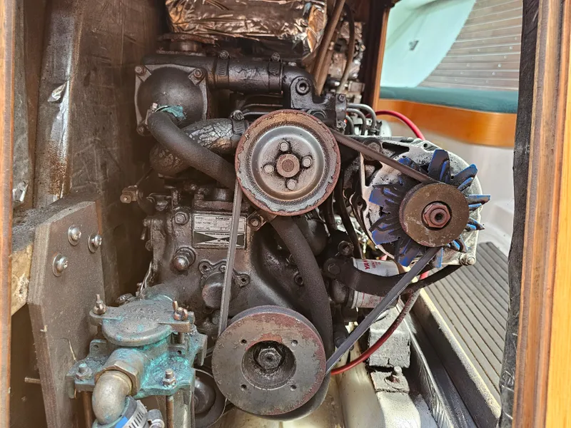 Slide: The Image of Engine compartment of a 1987 Express 37, showcasing belts and components. - 21