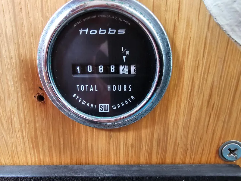 Slide: The Image of Hobbs hour meter showing 1088.2 total hours on wood panel, Express 37, 1987. - 23