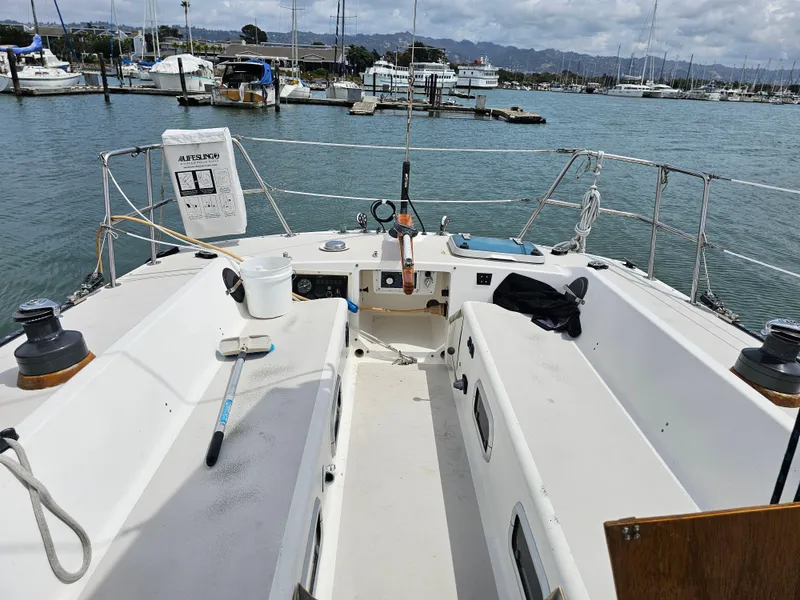 Slide: The Image of Sailboat cockpit view, Express 37, 1987 model, docked at marina with scenic background. - 3