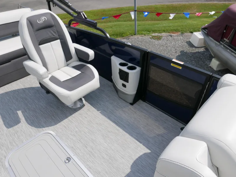 Slide: The Image of 2022 Barletta Corsa 23UC boat interior with plush seating and cup holders. - 16