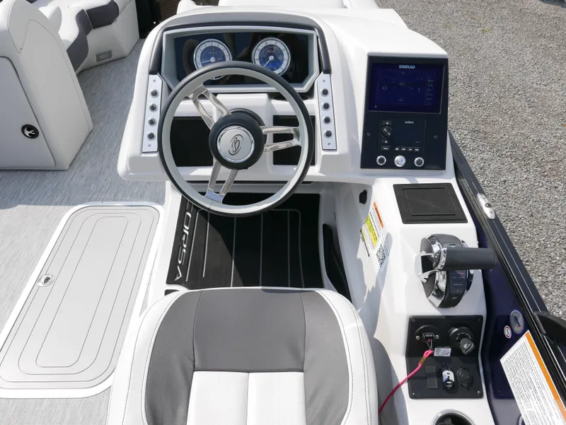 Slide: The Image of 2022 Barletta Corsa 23UC boat dashboard with steering wheel and control panel. - 22