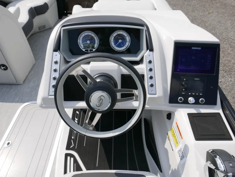 Slide: The Image of 2022 Barletta Corsa 23UC boat dashboard with steering wheel and control panel. - 24