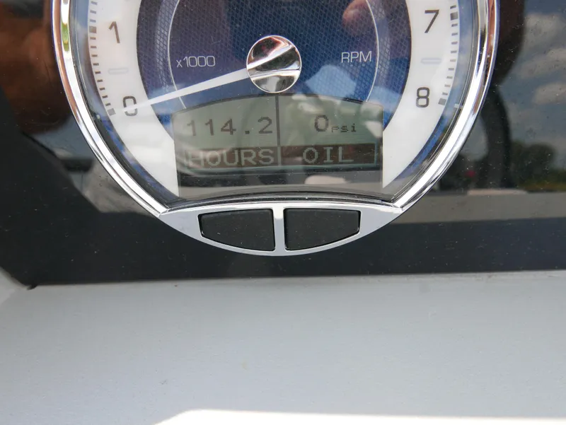 Slide: The Image of Close-up of 2022 Barletta Corsa 23UC boat gauge showing RPM and oil hours. - 25