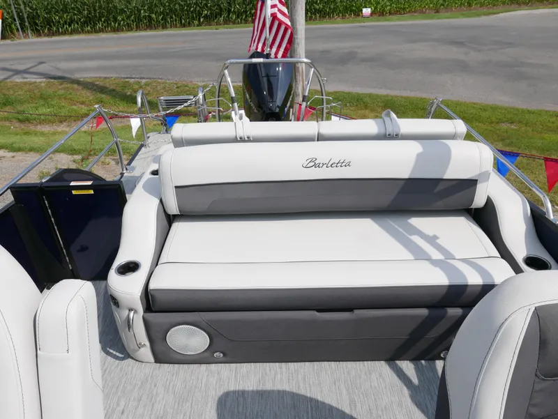 Slide: The Image of 2022 Barletta Corsa 23UC boat interior with plush seating and American flag. - 28