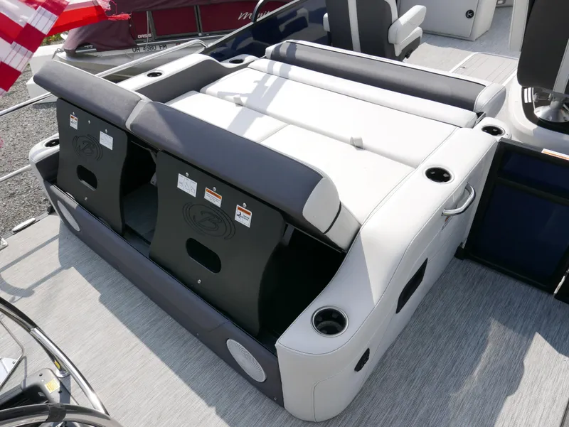 Slide: The Image of 2022 Barletta Corsa 23UC boat seating area with cup holders and storage compartments. - 35