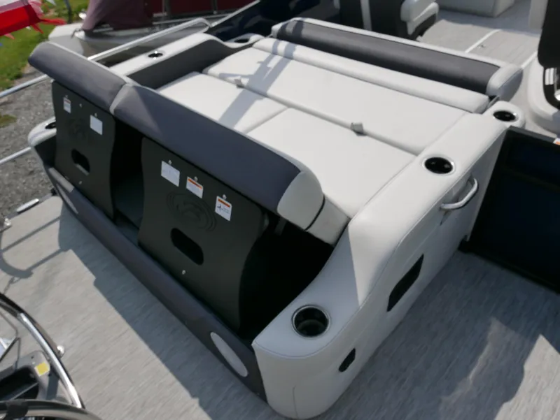 Slide: The Image of 2022 Barletta Corsa 23UC boat seating area with cup holders and storage compartments. - 36