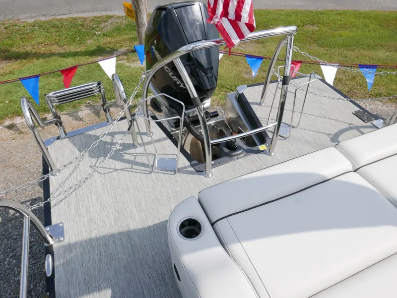 Slide: The Image of 2022 Barletta Corsa 23UC pontoon boat deck with motor and seating area. - 40