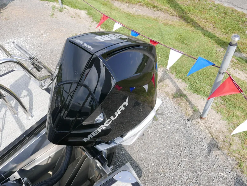 Slide: The Image of Mercury outboard motor on 2022 Barletta Corsa 23UC boat, with colorful pennant flags. - 41