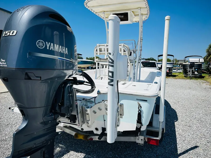 Slide: The Image of 2021 Sportsman Tournament 214 SBX Bay Boat with Yamaha 150 engine, parked on gravel. - 10