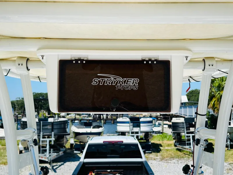 Slide: The Image of 2021 Sportsman Tournament 214 SBX Bay Boat with Stryker T-Tops, docked near trailers. - 14