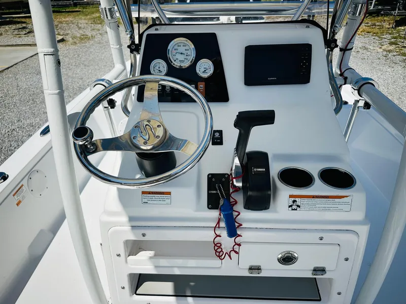 Slide: The Image of 2021 Sportsman Tournament 214 SBX Bay Boat console with steering wheel and controls. - 15