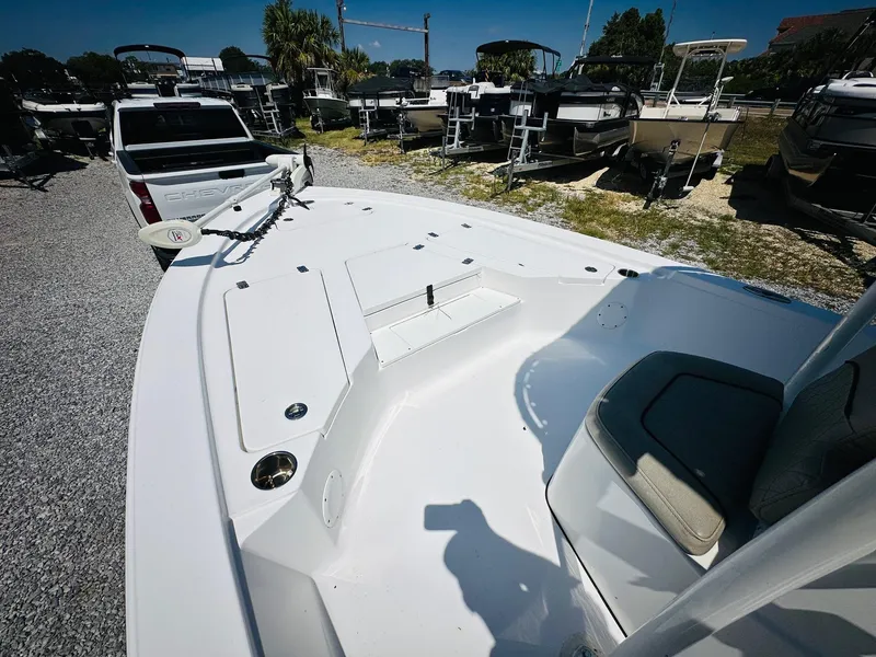 Slide: The Image of 2021 Sportsman Tournament 214 SBX Bay Boat, white deck, parked outdoors. - 17