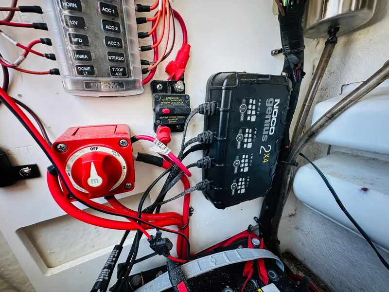 Slide: The Image of Electrical system of a 2021 Sportsman Tournament 214 SBX Bay Boat, featuring wiring and a Noco Genius charger. - 23