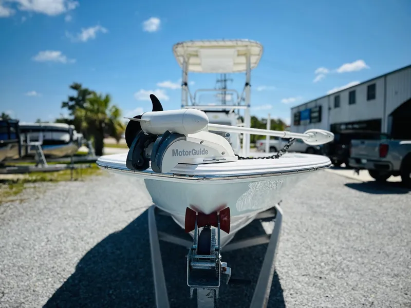 Slide: The Image of 2021 Sportsman Tournament 214 SBX Bay Boat with MotorGuide, parked on gravel lot. - 3
