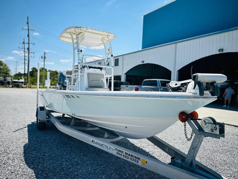 Slide: The Image of 2021 Sportsman Tournament 214 SBX Bay Boat on trailer outside a marine dealership. - 4