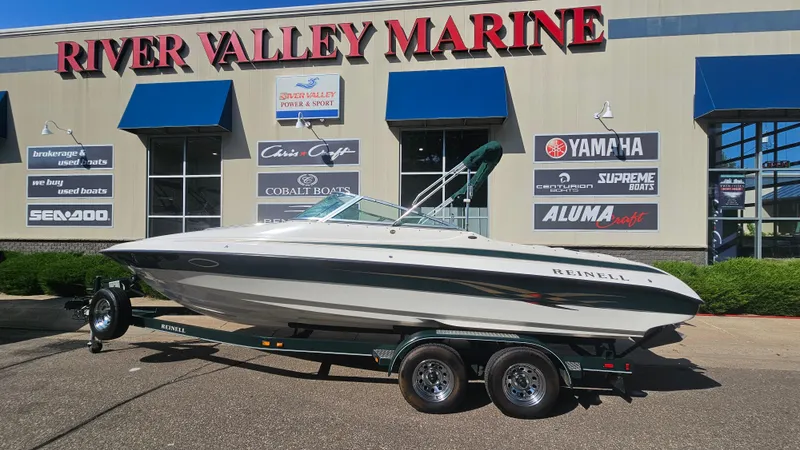 Slide: The Image of 2001 Reinell 240 C boat on trailer at River Valley Marine dealership. - 1