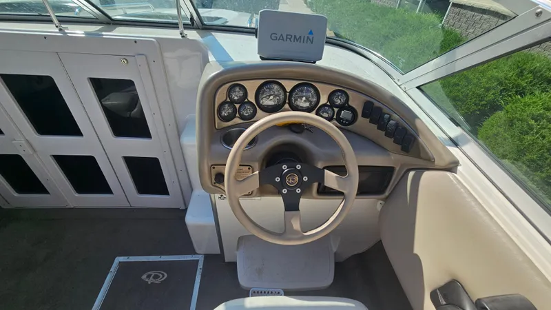 Slide: The Image of 2001 Reinell 240 C boat dashboard with Garmin navigation system and steering wheel. - 10