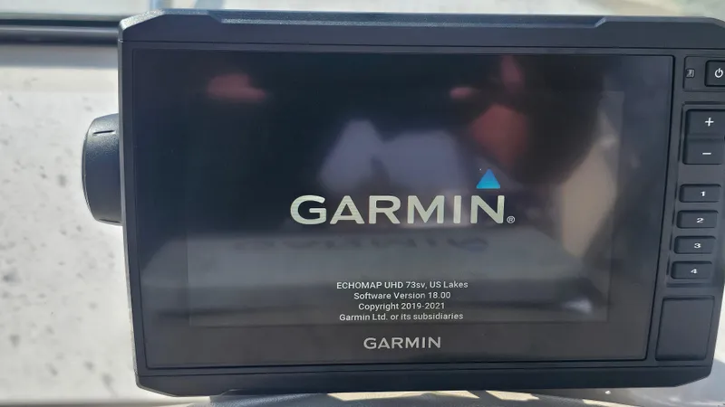 Slide: The Image of Garmin device on a 2001 Reinell 240 C boat, displaying startup screen. - 11