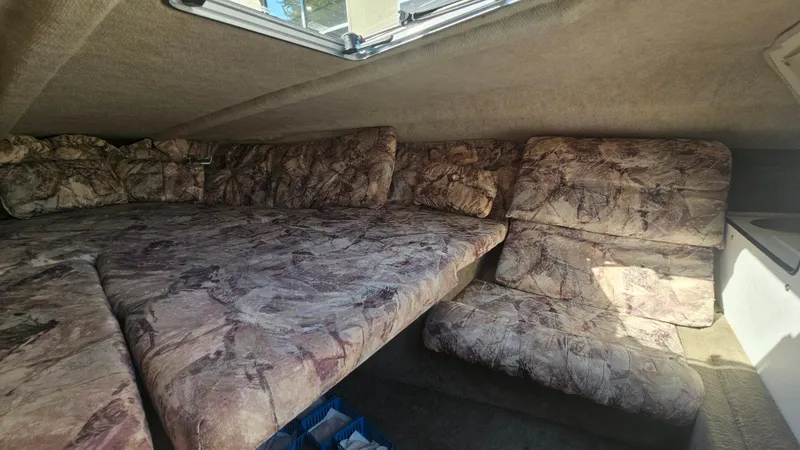 Slide: The Image of Interior cabin of a 2001 Reinell 240 C boat with patterned upholstery. - 13