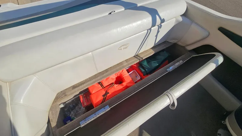 Slide: The Image of 2001 Reinell 240 C boat storage compartment with life jackets and gear. - 17
