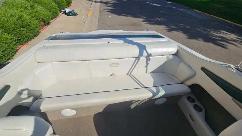 Slide: The Image of 2001 Reinell 240 C boat interior with white seating and cup holders. - 7