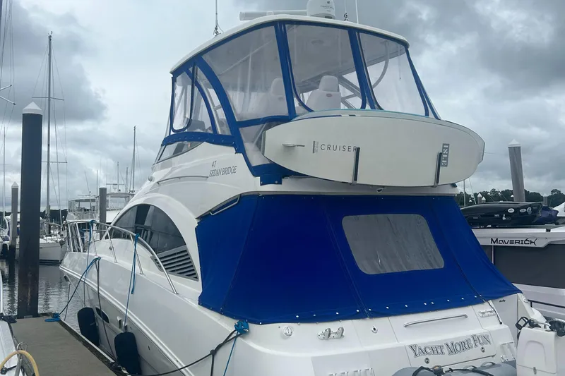 Slide: The Image of 2008 Sea Ray 47 Sedan Bridge yacht docked, featuring blue and white design. - 1