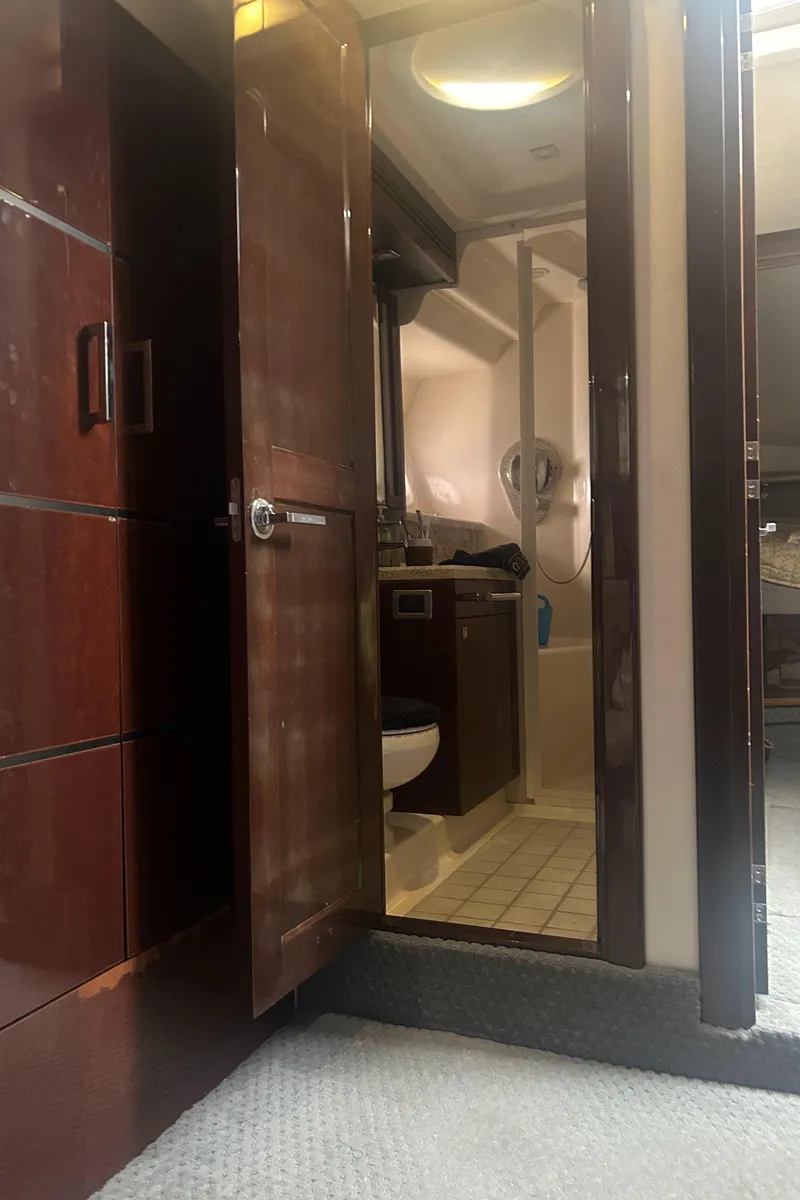 Slide: The Image of Interior of 2008 Sea Ray 47 Sedan Bridge yacht bathroom with wooden door. - 14