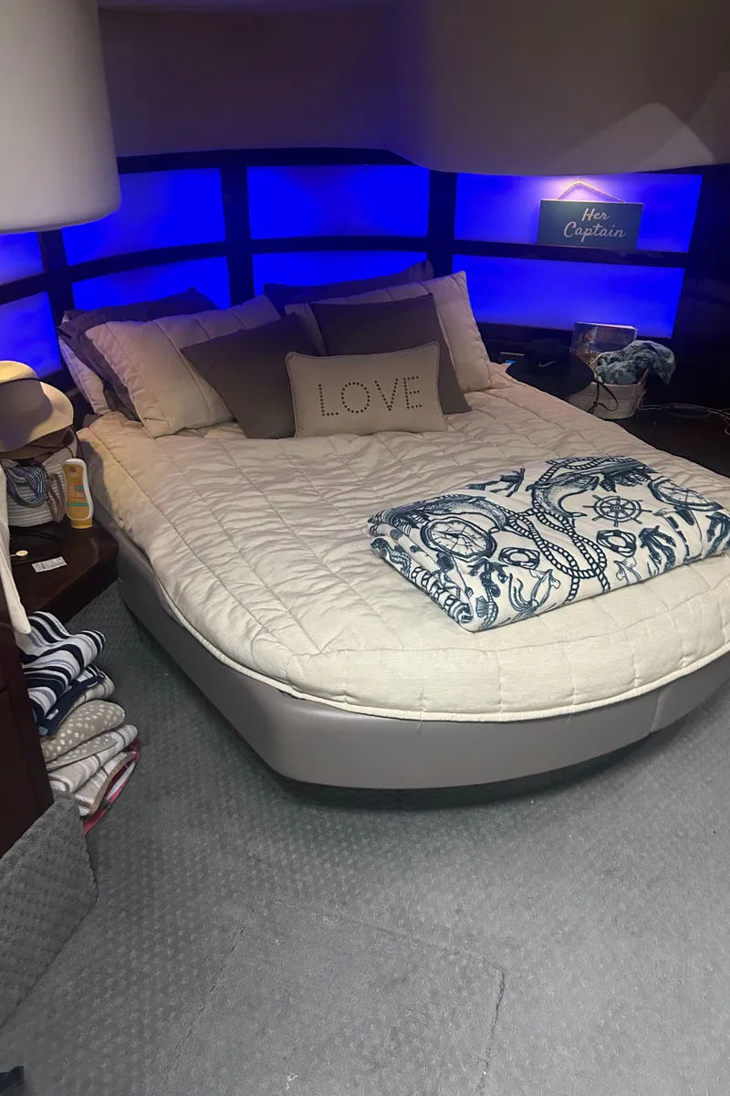 Slide: The Image of Luxurious bedroom in 2008 Sea Ray 47 Sedan Bridge yacht with cozy bedding and ambient lighting. - 16