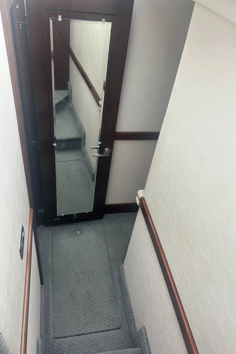 Slide: The Image of Interior staircase of 2008 Sea Ray 47 Sedan Bridge yacht with mirrored door. - 17