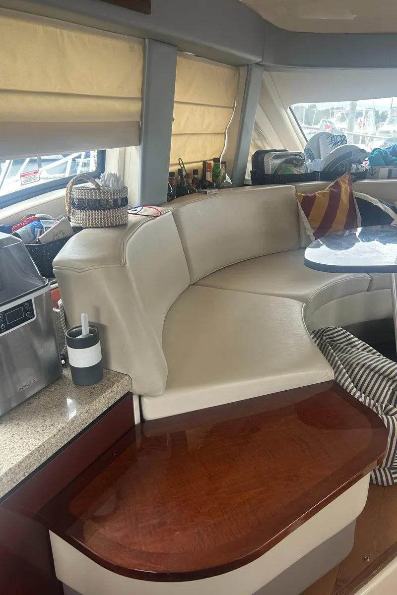 Slide: The Image of Interior of 2008 Sea Ray 47 Sedan Bridge with beige seating and wooden accents. - 19