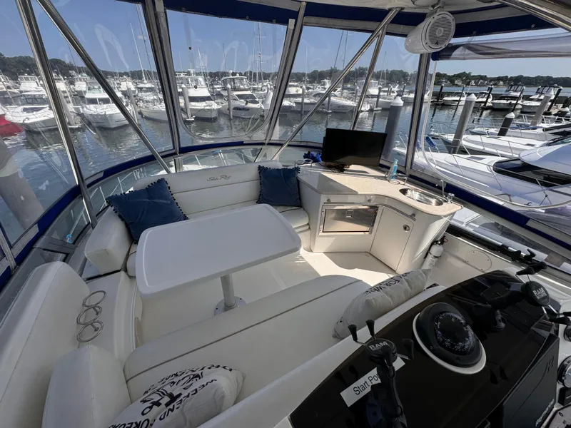Slide: The Image of Interior of 2008 Sea Ray 47 Sedan Bridge yacht with marina view. - 2